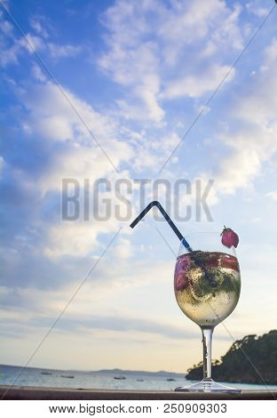 Misted Glass With A Champagne Cocktail On The Beach Background. Vertical.