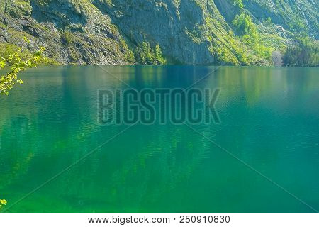 Bright Green Surface Of The Lake Obersee With The Reflection Of The Rock.