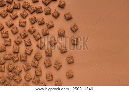 Top View Of Cereal Pillows On Browm Background With Copy Space