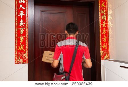 Zhongshan,china-june 3,2018:male Courier From Jd.com Delivering A Parcel To The Customers Home.june 