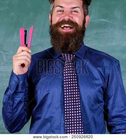 School Stationery. Man Smiling Hold Stapler Stationery. Hipster Teacher Formal Necktie Holds Stapler