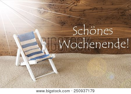 Sunny Summer Greeting Card With Sand And Aged Wooden Background. German Text Wochenende Means Weeken