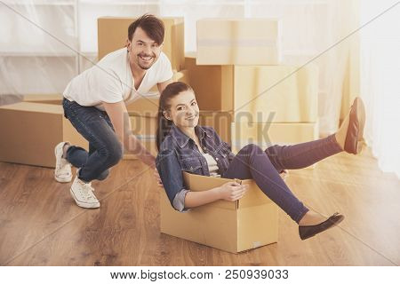 Happy Couple Is Having Fun. People With Boxes. Family In New Flat. European Man And Woman. Fooling A