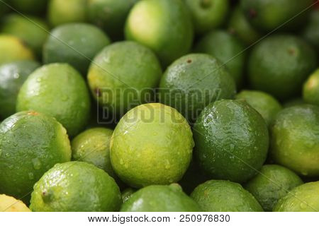 Fresh Green Limes On The Fruit Market. Close-up Photo