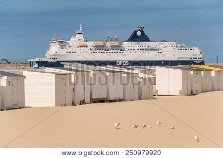 Calais, France - 19 June 2018: Beach Cabins And Dfds Cross Channel Ferry On Its Way To Dover, Uk.
