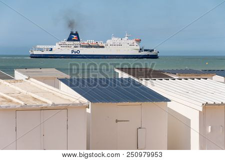 Calais, France - 19 June 2018: Beach Cabins And P&o Cross Channel Ferry On Its Way To The Port.