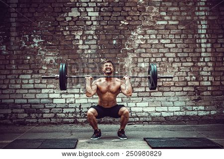 Muscular Fitness Man Doing Deadlift A Barbell Over His Head In Outdoor, Street Gym. Functional Train