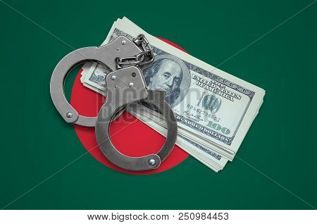 Bangladesh Flag  With Handcuffs And A Bundle Of Dollars. Currency Corruption In The Country. Financi
