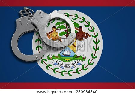 Belize Flag  And Police Handcuffs. The Concept Of Crime And Offenses In The Country.