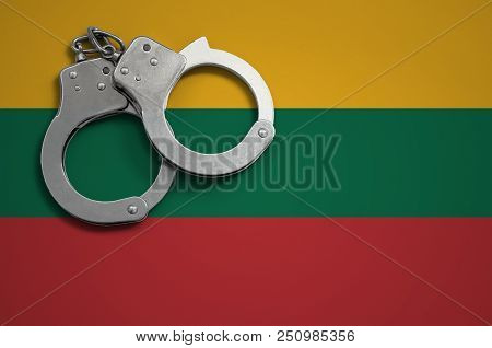 Lithuania Flag  And Police Handcuffs. The Concept Of Crime And Offenses In The Country.
