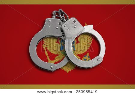 Montenegro Flag  And Police Handcuffs. The Concept Of Observance Of The Law In The Country And Prote