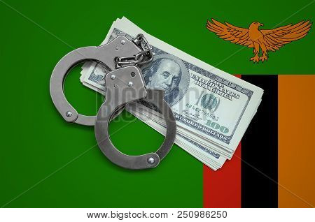 Zambia Flag  With Handcuffs And A Bundle Of Dollars. Currency Corruption In The Country. Financial C