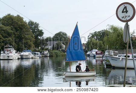 Beccles, Suffolk, Uk, July 2018 - Man And Boy In A Sailing Boat On The River Waveney, Beccles, Suffo