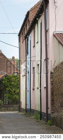View Of A Passage With Colourful Houses In The Historic Market Town Of Beccles, Suffolk, Uk
