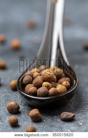 Jamaican Pepper In A Black Spoon.