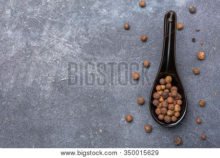 Allspice Pepper On Dark Background.