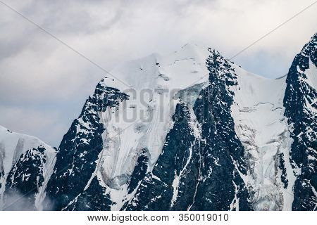 Atmospheric Minimalist Alpine Landscape With Massive Hanging Glacier On Snowy Mountain Peak. Big Bal