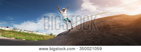 Portrait Of A Young Skateboarder Doing A Trick On His Skateboard On A Halfpipe Ramp In A Skate Park 