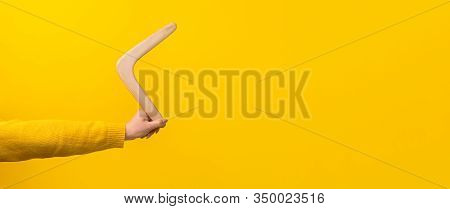 Boomerang In Female Hand Over Yellow Background, Panoramic Mock-up