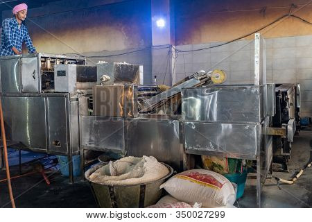 Amritsar India - Febuary 8, 2020: Sikh Man Watches His Automatic Machine Prepare Chapati - Tradition