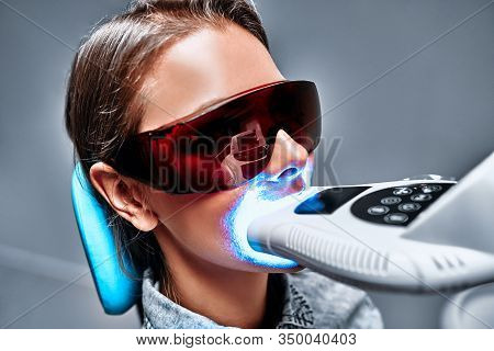Close-up View Portrait Of A Female Patient At Dentist In The Cli