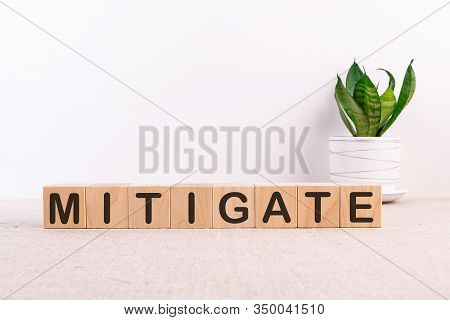 Mitigate Word Made With Building Blocks On A Light Background