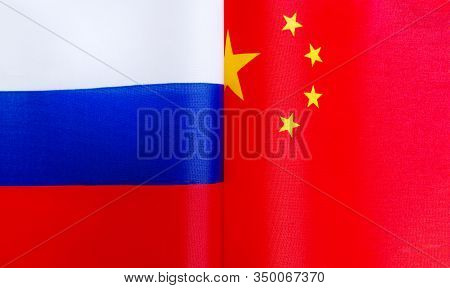 Fragments Of National Flags Of The Russian Federation And China In Close-up