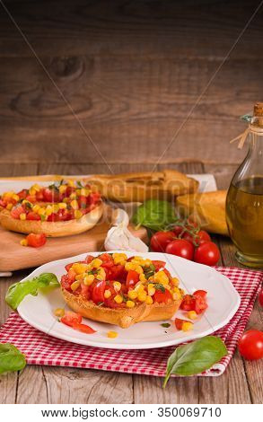 Friselle With Tomatoes And Mais On White Dish.