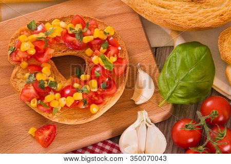 Friselle With Tomatoes And Mais On White Dish.
