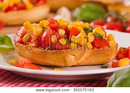 Friselle With Tomatoes And Mais On White Dish.