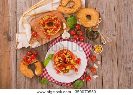 Friselle With Tomatoes And Mais On White Dish.