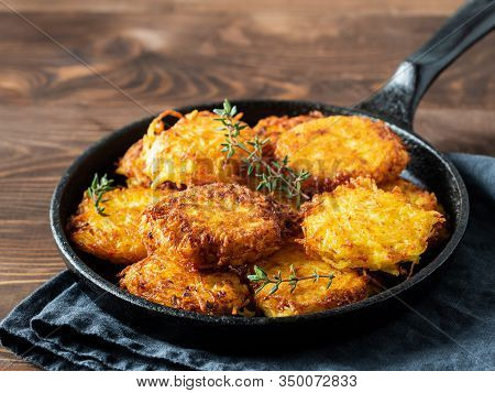 Potatoes Pancakes Latkes, Flapjacks, Hash Brown Or Potato Vada On Brown Wooden Table. Copy Space For