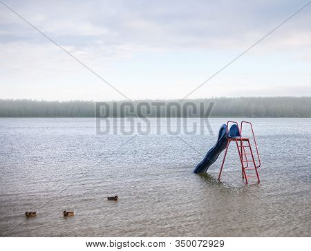 Beautiful View Of The Biale Lake, Poland.  Morning Fog Over The Lake And A Flock Of Ducks