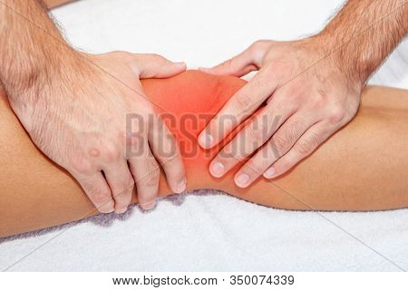 chiropractor or physiotherapist doing a massage to an injured sports person