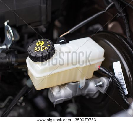 The Tank With Brake Fluid In The Car In The Engine Compartment. The Concept Of The Working Brake Sys
