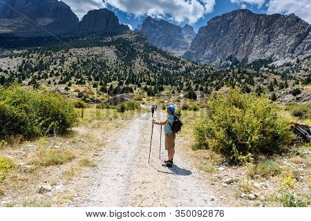 Turkey, Chamard - August 3, 2019: Tourist Watchs Around And Stays On The Road Through The Mountain L