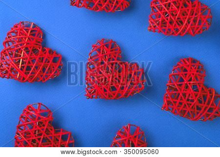 Beautiful Pattern Of The Red Wicker Hearts On The Cornflowerblue Background. St Valentines Concept F