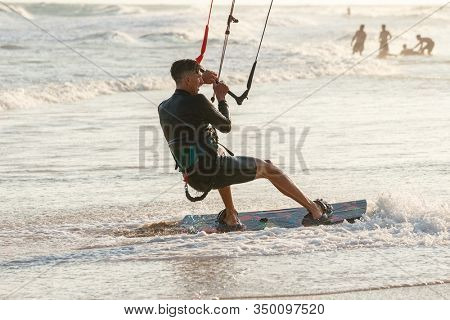 Kitesurfing on the waves of the sea in Mui Ne beach, Phan Thiet, Binh Thuan, Vietnam. Kitesurfing, Kiteboarding action photos Kitesurfer In action