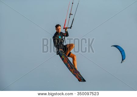 Kitesurfing on the waves of the sea in Mui Ne beach, Phan Thiet, Binh Thuan, Vietnam. Kitesurfing, Kiteboarding action photos Kitesurfer In action