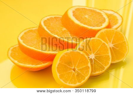 Fresh And Juicy Orange And Lemon Fruit Slices On The Yellow Background, Healthy Food