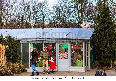 Poznan, Poland - February 9, 2020: Man, Woman And Child Standing In Front Of A Closed Umberto Restau
