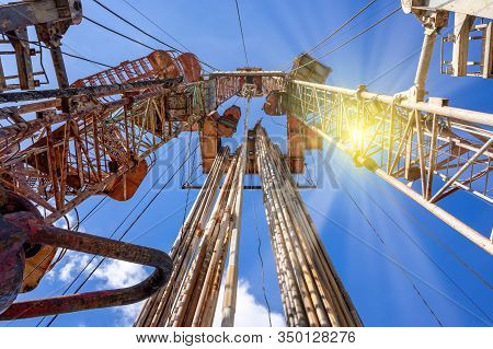 Oil And Gas Drilling Rig Onshore Dessert With Dramatic Cloudscape. Oil Drilling Rig Operation On The