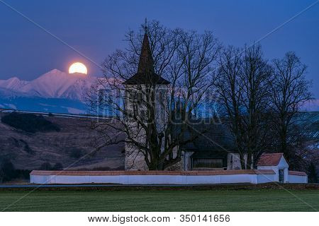 Full Moon On The Sky, Mountains At Background  And Lonely Gothic Church Of All Saints Ludrová, Slova