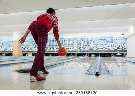 Bowling Game. Man Having Fun Playing Bowling In Club Throwing Ball On Lane. Kegling