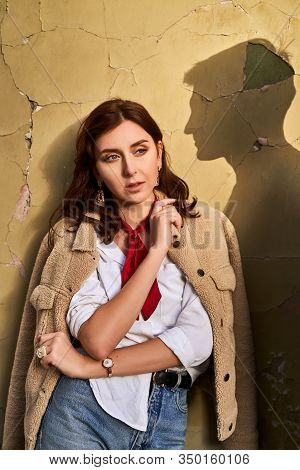 Beautiful Young Redhead Woman Wearing Teddy Jacket And White Shirt And Red Neckpiece Is Thinking Of 