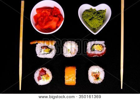A Set Of Rolls Of Different Kinds With Wasabi, Red Marinated Imbere And Sushi Sticks, Isolated On A 