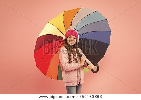 If It Should Rain. Happy Small Child In Coat Hold Colorful Umbrella Against Rain. Cute Little Girl W