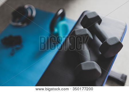 Home Gym And Fit Lifestyle Still-life, Room With Flat Bencha Nd Dummbells Surrounded By Other Fitnes