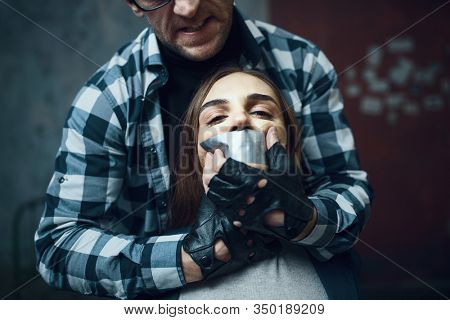 Maniac kidnapper tormenting his scared victim