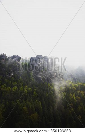 Panoramic View Of The Elbe Sandstone Mountains Covered In Fog In Saxony, Germany
